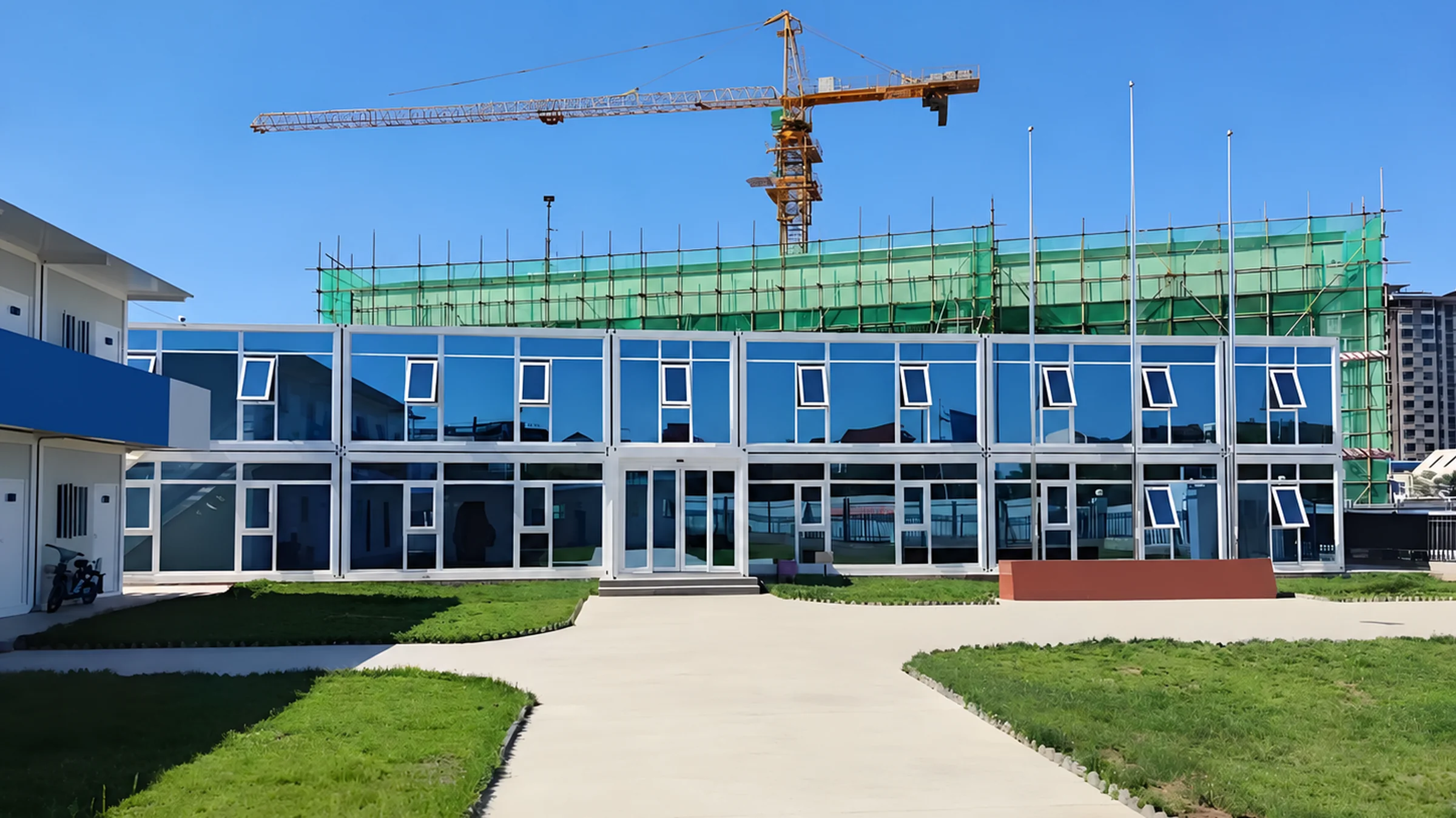 Two-storey flat-pack container office with a blue glass facade.